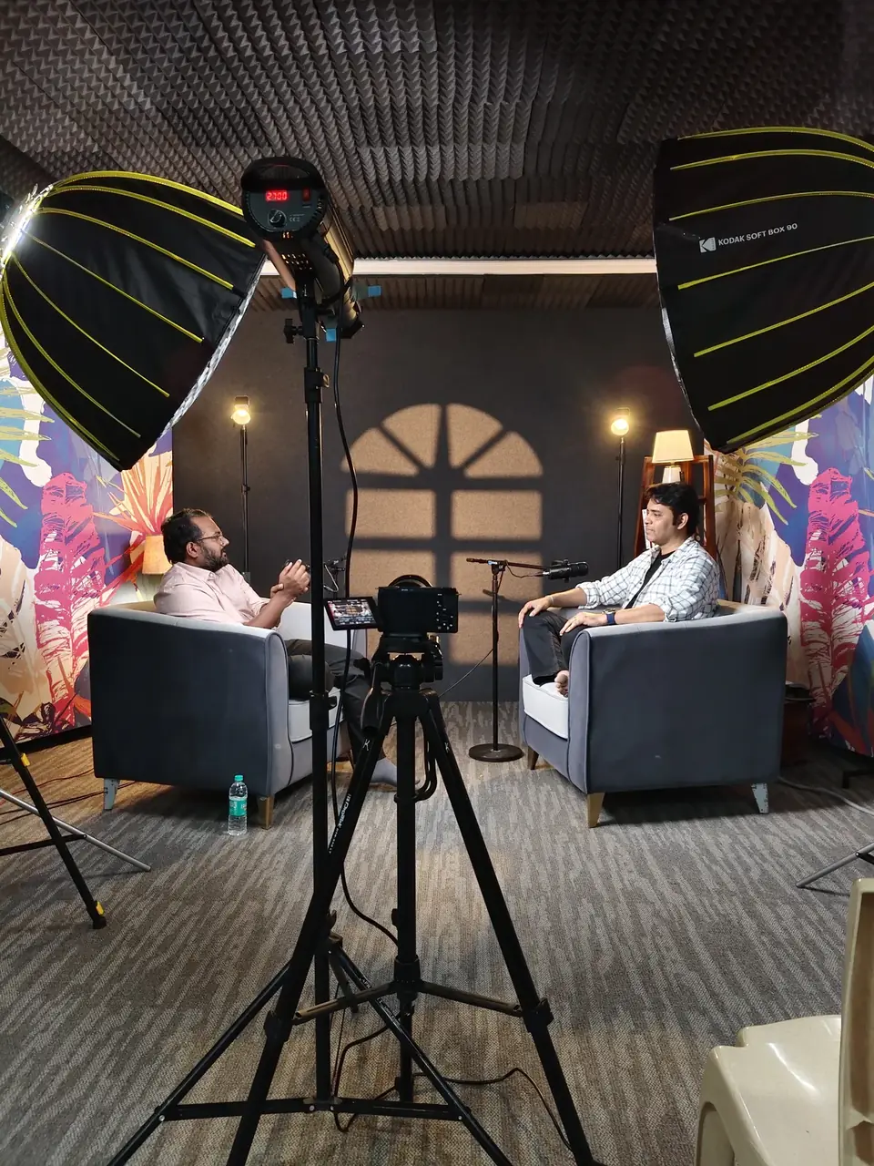 Podcast set with cameras, lighting and two speakers